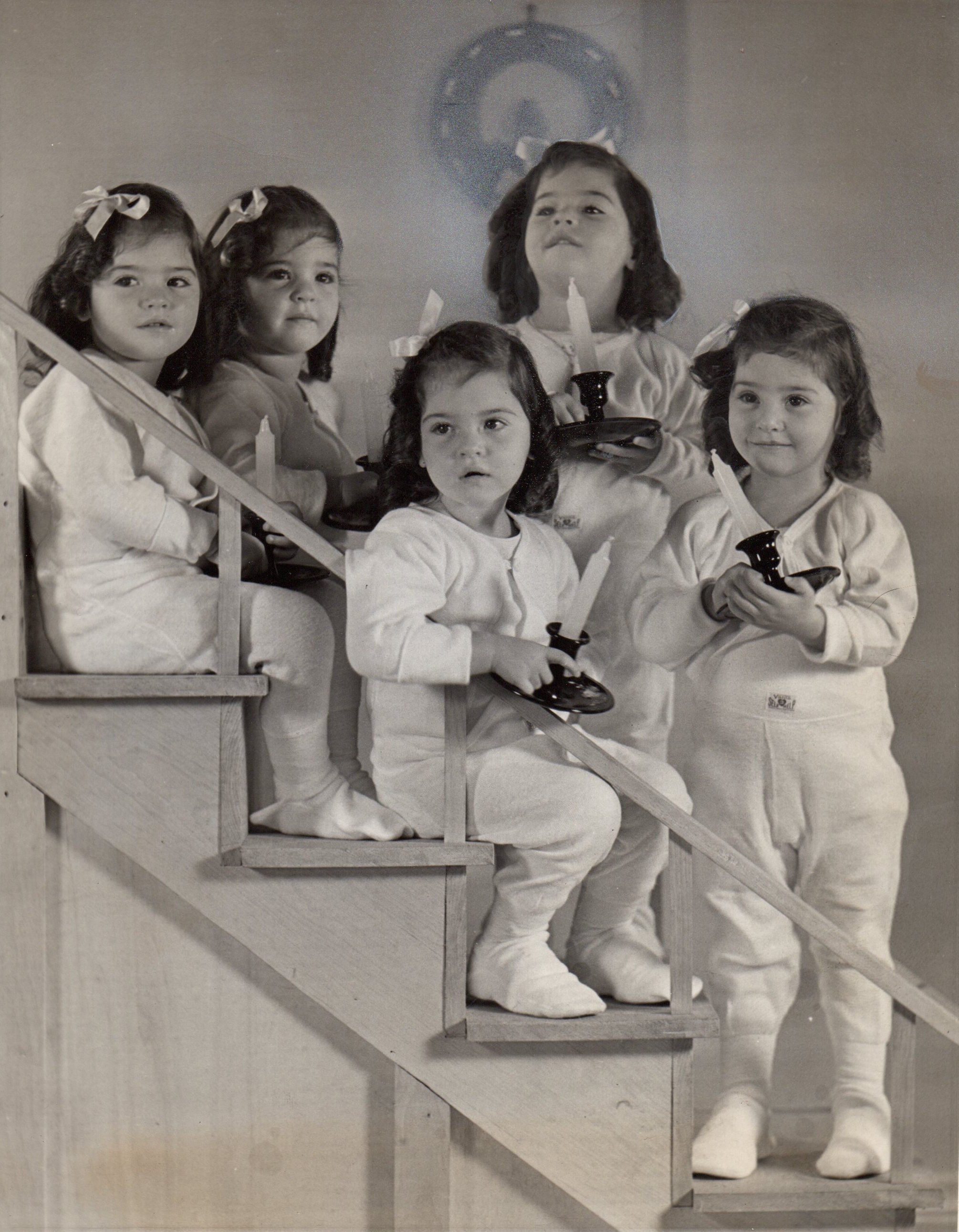 Annette, Yvonne, Cécile, Émilie, and Marie Dionne holding candles, 1938
